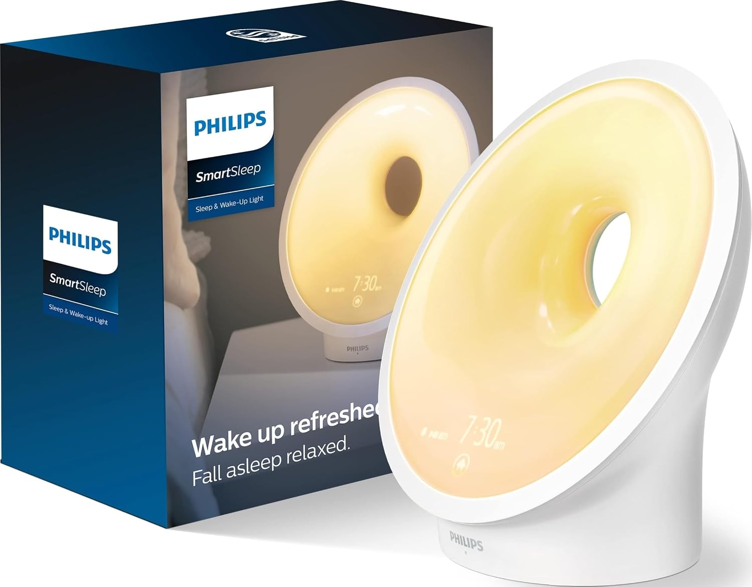 Philips SmartSleep Wake-Up Light sunrise alarm clock glowing amber, next to its retail box